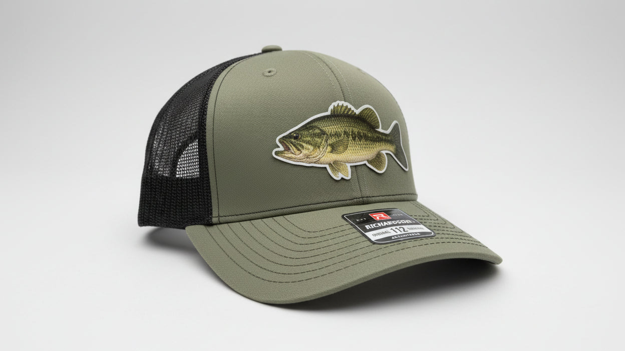 Loden and black trucker hat featuring a Largemouth Bass fish‑design patch on a white background, Hollarwood Outfitters