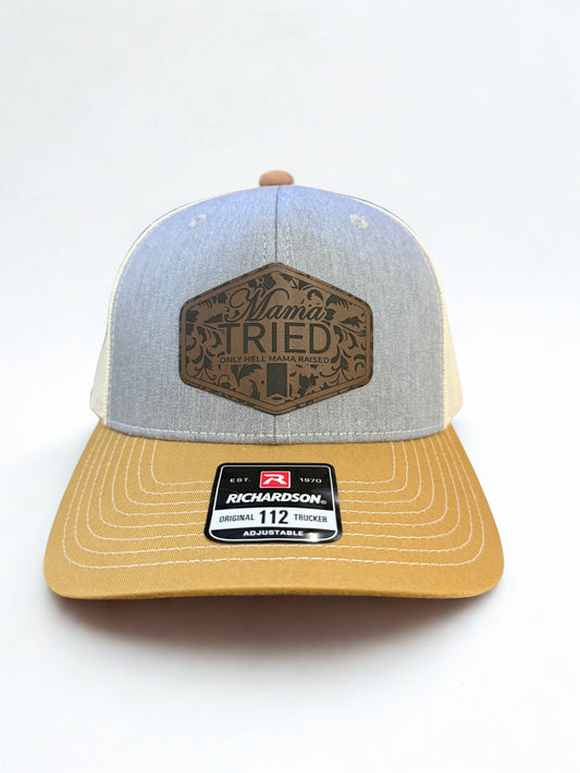 Mama Tried dark Leather patch on a heather/birch/amber gold trucker hat hollarwood outfitters