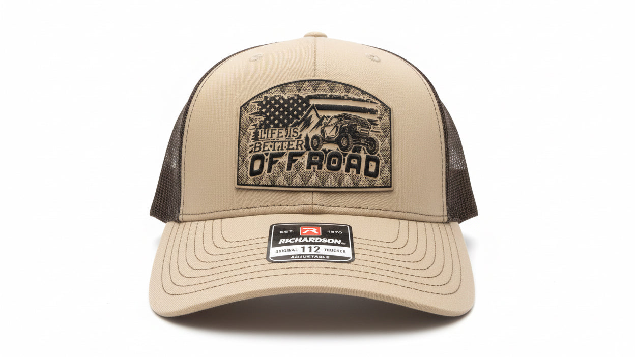Khaki and chocolate‑brown trucker hat with a leather ‘Life Is Better Off Road’ patch on a white background, Hollarwood Outfitter