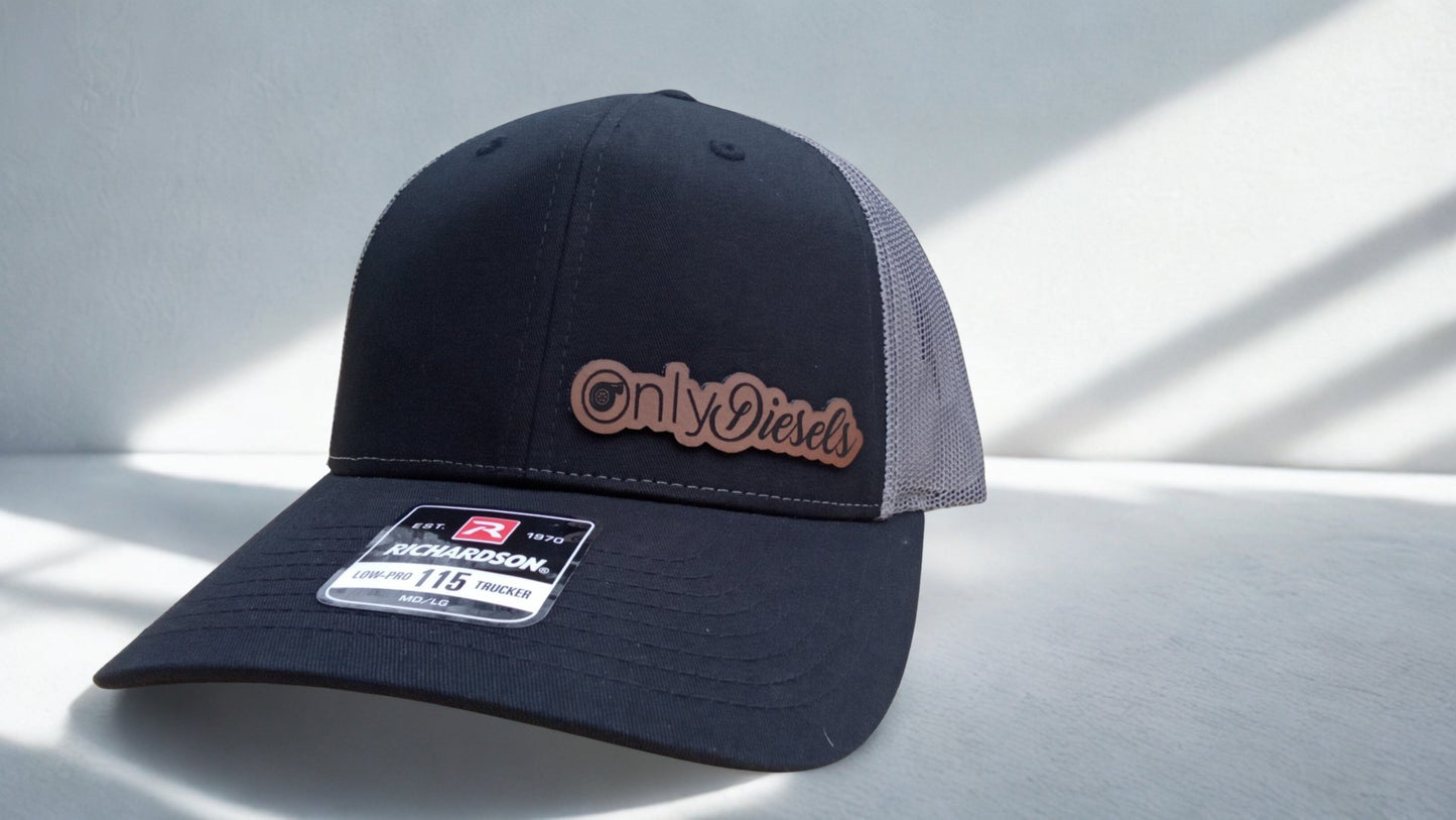Black and charcoal trucker hat featuring a leather ‘Only Diesels’ patch on a light background, Hollarwood Outfitters