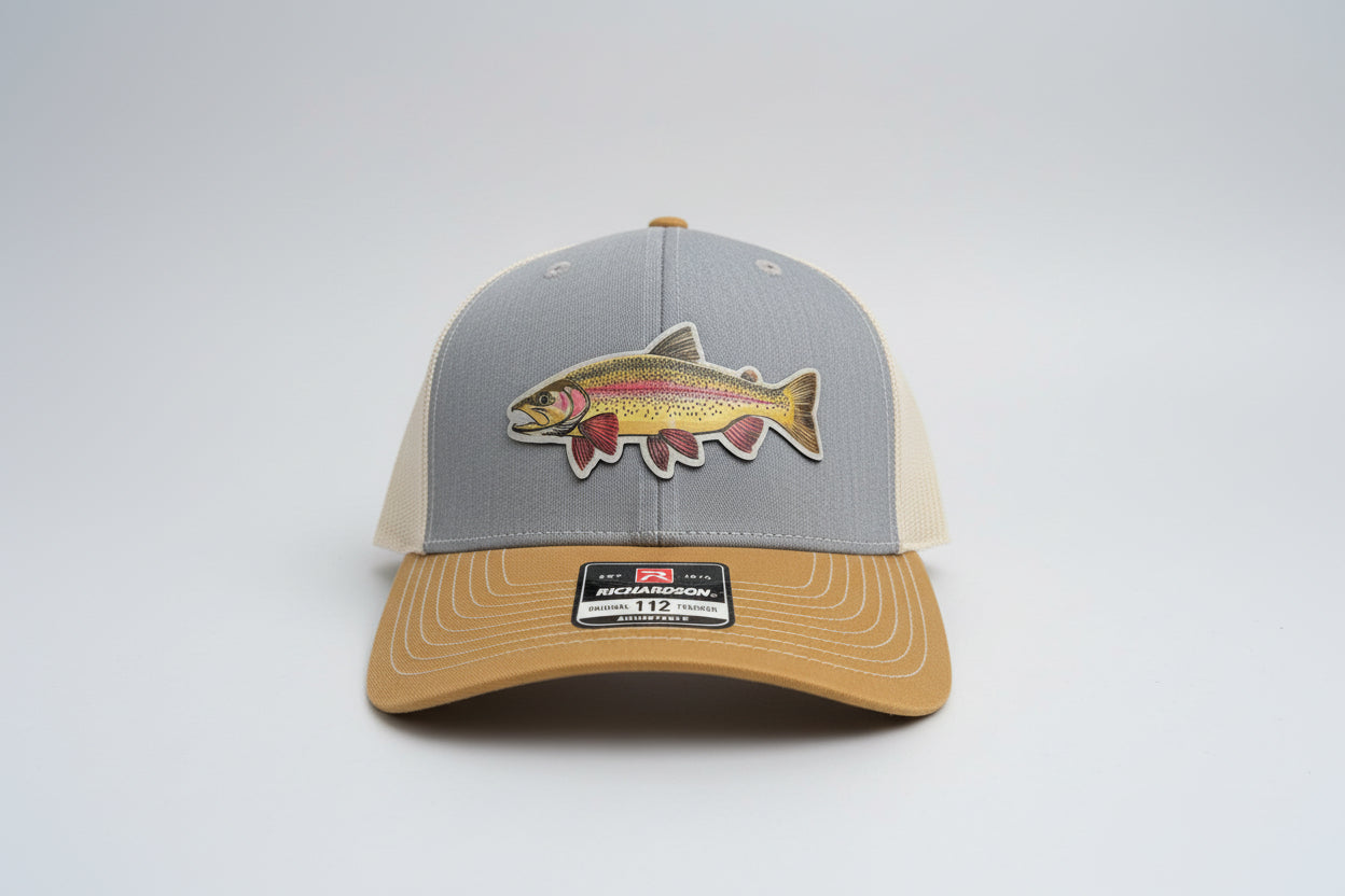 Gray and brown trucker hat featuring a leather rainbow trout patch on a white background, Hollarwood Outfitters