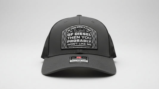 Black cap featuring the ‘The Smell of Diesel’ text and logo on a light gray background, Hollarwood Outfitters